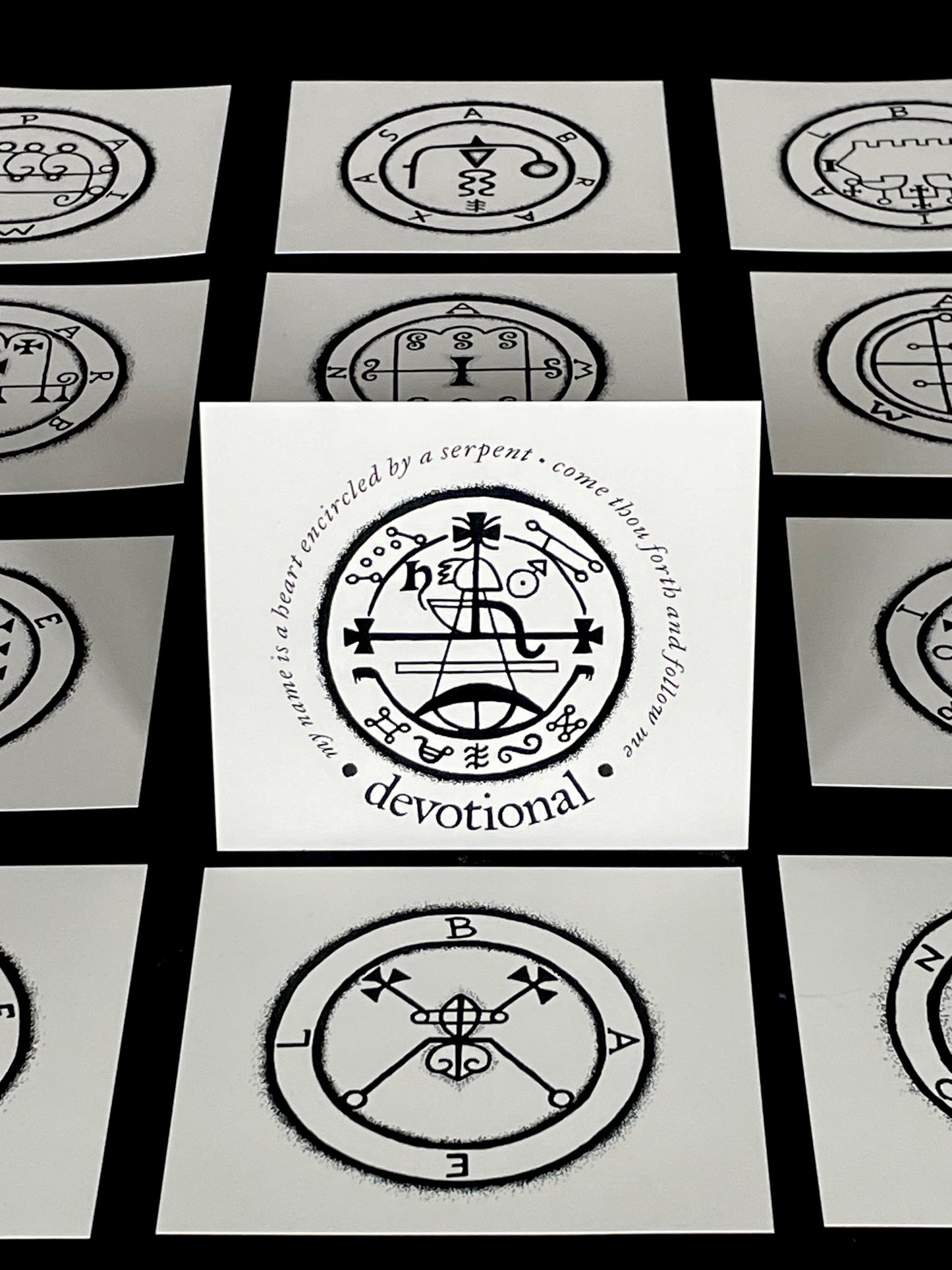 Set of cards with black and white symbols and text on a black background