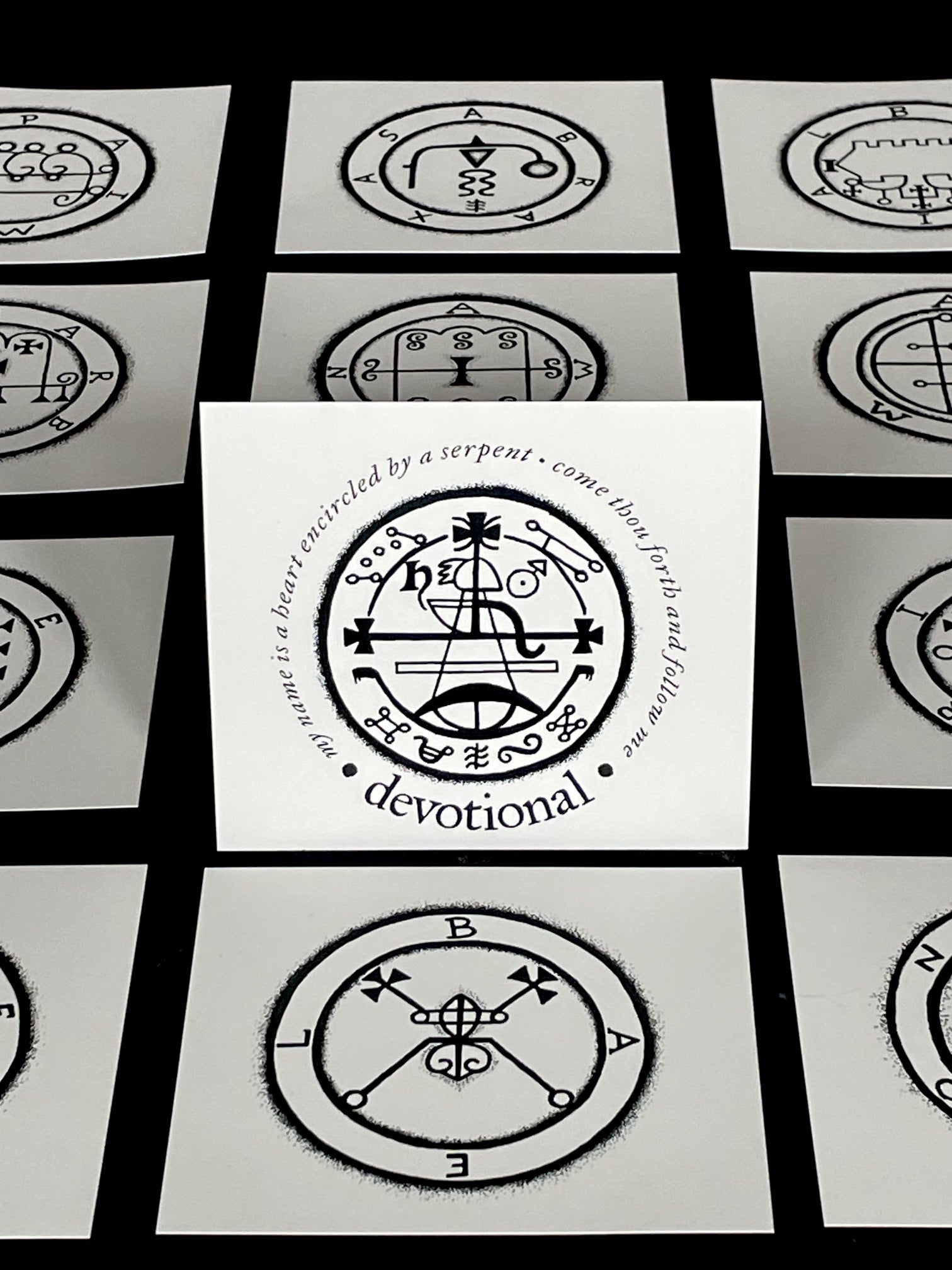 Set of cards with black and white symbols and text on a black background