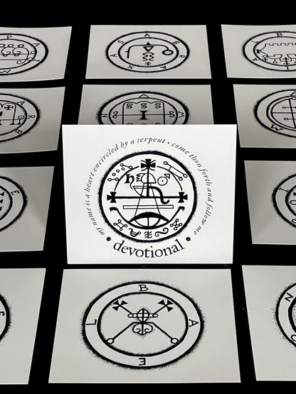 Set of cards with black and white symbols and text on a black background